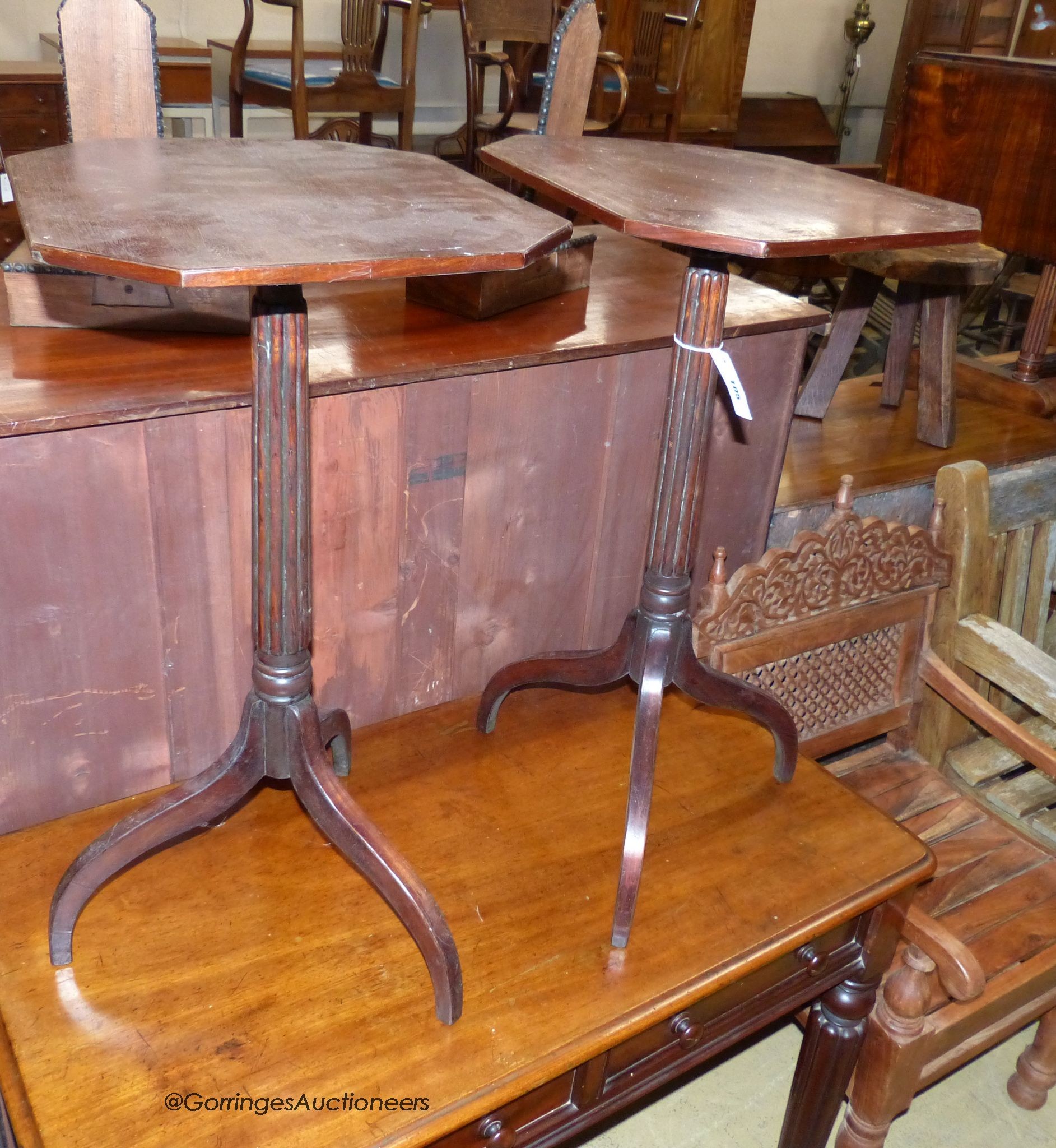 A pair of Regency style octagonal mahogany tripod wine tables, width 42cm, depth 36cm, height 71cm